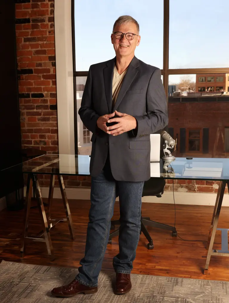 Daniel C. Clark standing in a brick-lined room